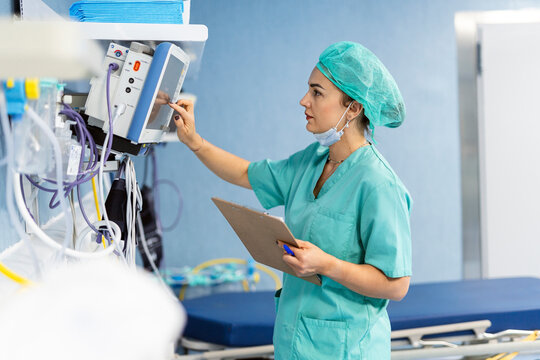 Nurse monitoring patient vitals in intensive care unit
