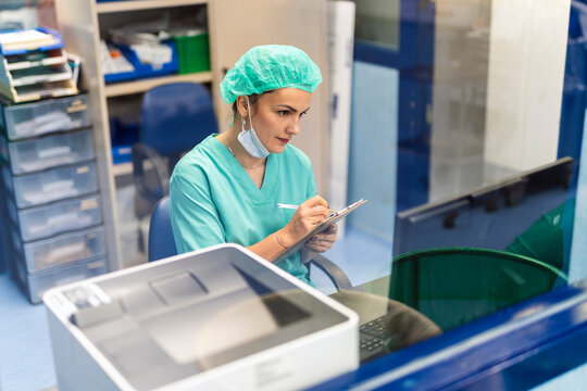 Healthcare professional writing patient records in clinic