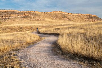 walking and hiking trail in northern Colorado foothills with a distant hiker- Bobcat RIdge Natural Area