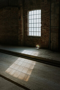 Sunlight streaming through a rustic warehouse window