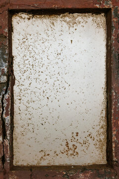 Weathered wall texture with exposed bricks and cracks