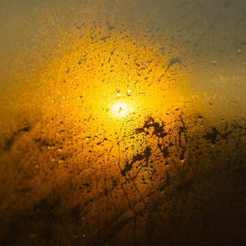 Wet window at sunset