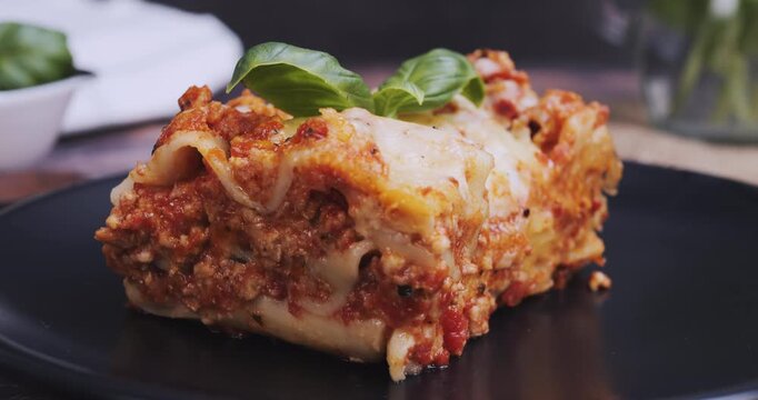 Freshly baked portion of lasagna served on a plate, highlighting Italian cuisine, homemade comfort food, and gourmet dining concept.