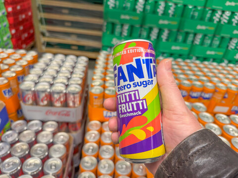 Germany Berlin February 7, 2026. Hand holding a Fanta Zero Sugar Tutti Frutti can in a store aisle. Bright packaging highlights modern soft drink marketing and choice.