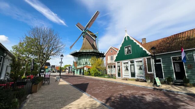traditional Dutch windmills of Zaanse Schans over water at summer sunset, Netherlands