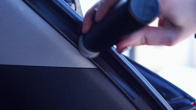 woman lubricates the rubber of the car trunk with silicone in winter. car protection from winter frosts. car care
