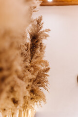 Obraz premium Boho fireplace mantel with macrame wall hanging, candles and dried flowers