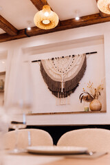 Obraz premium Boho fireplace mantel with macrame wall hanging, candles and dried flowers