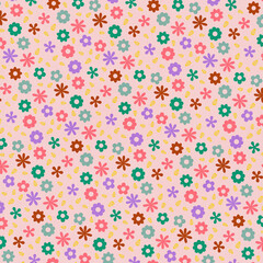 Seamless colorful floral pattern with scattered flowers on soft pink background. Cheerful playful design perfect for kids products, textiles, and creative decor.