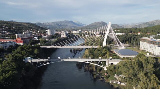 Flying forwards above the Moraca river in Podgorica, Crna Gora. Aerial drone video, panoramic view.