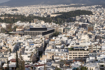 Naklejka premium High angle view of Athens city from Filopappou Hill with compact white buildings, dense urban structure and mountain landscape in Greece.