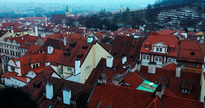 Wide winter overview of Prague Old Town from Strahov Monastery. Blue early morning atmosphere highlights historic architecture and iconic landmarks in a calm, cinematic cityscape.