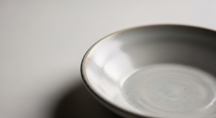 Empty white ceramic bowl on white background with copy space