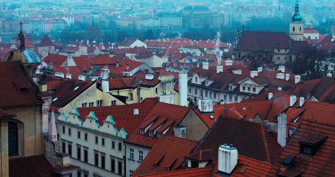 Wide winter overview of Prague Old Town from Strahov Monastery. Blue early morning atmosphere highlights historic architecture and iconic landmarks in a calm, cinematic cityscape.