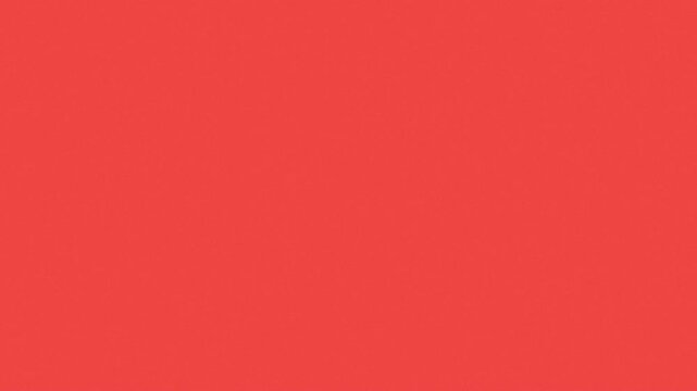 A flat, solid red background with even color distribution and no visible features