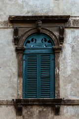Historic window with decorative stone frame in Verona, Italy