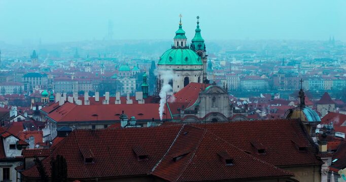 Wide winter overview of Prague Old Town from Strahov Monastery. Blue early morning atmosphere highlights historic architecture and iconic landmarks in a calm, cinematic cityscape.