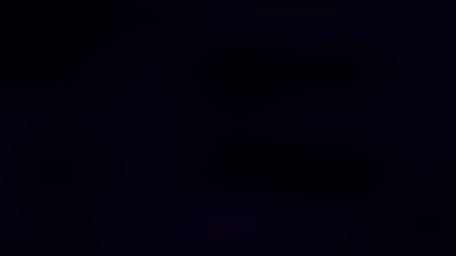 A dark, abstract image with flowing shapes and a gradient of deep colors