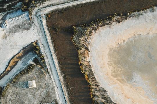 Aerial view of the contrasting whites of the salt, browns of the soil, and greens of the vegetation create a striking landscape, Laneuveville-devant-Nancy, Grand Est, France.
