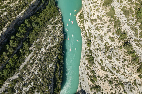 Aerial view of turquoise waters carving through rugged cliffs near 27 Rue Saint-Victor, a dance of light and shadow, Castellane, Provence-Alpes-Cote d'Azur, France.