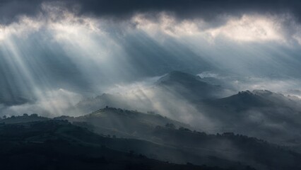 Fototapeta premium Sunrays Over Misty Mountain Landscape