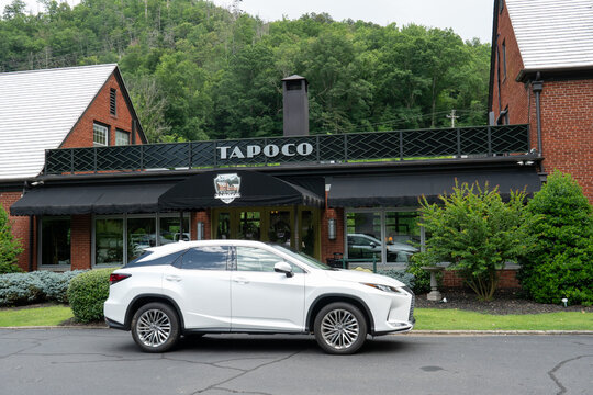 Robbinsville, North Carolina, US - June 28, 2021: White Lexus crossover vehicle a hotel lodge guest or possible a rideshare driver like uber of Lyft standing outside the TAPOCO main entrance, waiting 