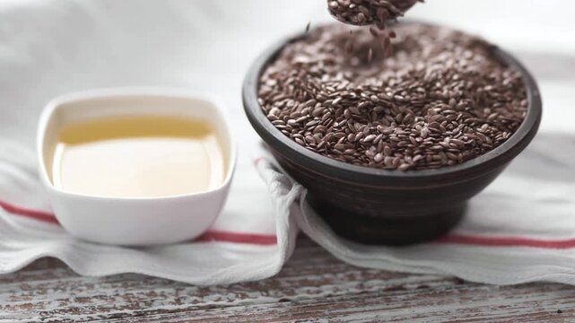 Organic linseed oil and seeds on rustic wooden surface, healthy nutrition.