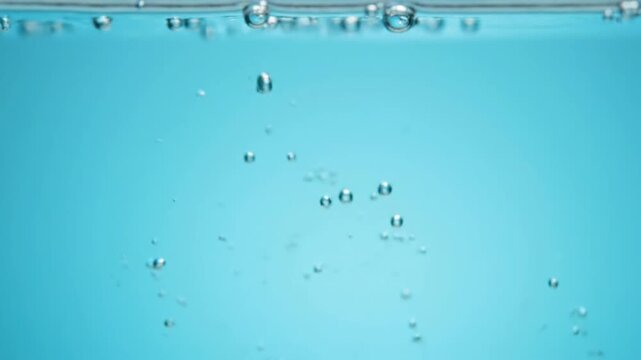 ultra slow motion of multiple micro air bubbles separating and drifting in different directions inside crystal clear water