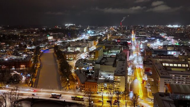 Night Aerial View of Frozen Aurajoki River and Turku Cityscape in Winter, Finland, 4K