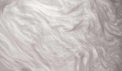 Obraz premium Shimmering silver abstract background. Liquid glitter paint texture waves and swirls. Beautiful shiny white glitter texture. Metallic silver paint close-up as a holiday background.