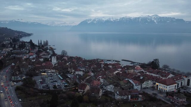 Aerial flight over Lutry old town and Lake Geneva with Alps, Switzerland