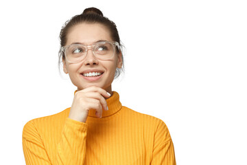 Thoughtful woman with hand on chin looking up wearing yellow turtleneck