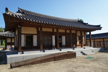 Fototapeta premium Traditional wooden house exterior in nature. Exterior view of a traditional wooden house surrounded by greenery, expressing calm and cultural atmosphere. 