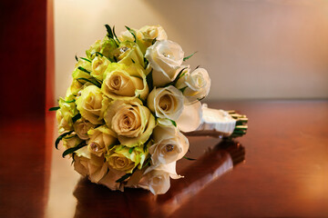 Elegant Wedding Bouquet of White and Cream Roses with Crystal Accents, with a soft warm background