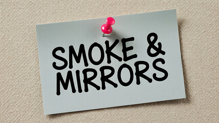 Close-up of 'Smoke & Mirrors' note pinned on corkboard with red pushpin, soft lighting