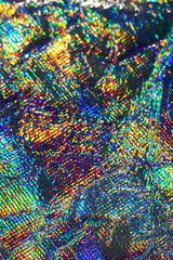 Vibrant iridescent holographic texture with rainbow color, abstract shimmer and kaleidoscopic pattern