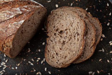 Sliced Sunflower Seed Bread Presentation. Artisan Sunflower Seed Bread on Rustic Surface. Freshly Sliced Sunflower Bread on Table. Healthy Sunflower Seed Bread Slices.