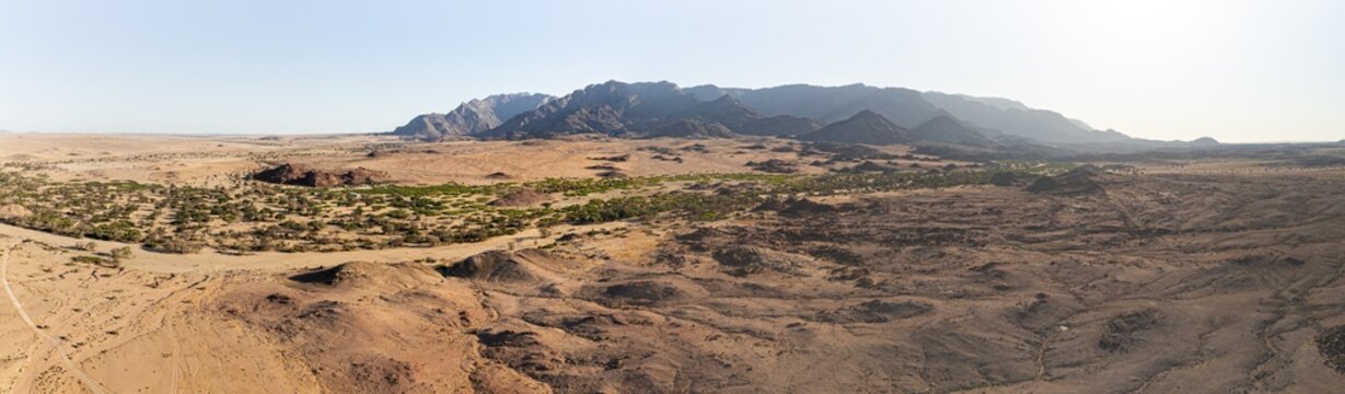 Aerial view, dry riverbed and desert landscape on the Ugab River, behind Brandberg, Erongo, Damaraland, Namibia