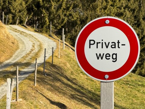 Prohibition sign, private road sign next to a dirt road in the mountains, Tyrol, Austria