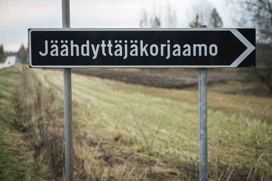 Long Finnish place name J&auml;&auml;hdytt&auml;j&auml;korjaamo with 19 letters on a road sign, near Heinola, Finland