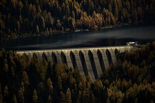 Dam of the Zufrittsee with autumnal mountain forest, Martell Valley, Merano, Vinschgau, South Tyrol, Italy