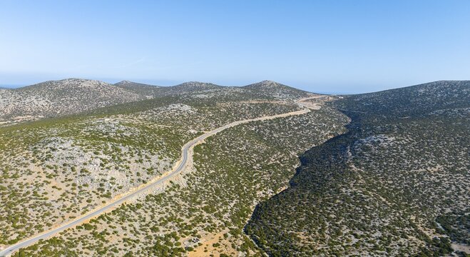 Lonely road in dry landscape, Astypalea, Greece