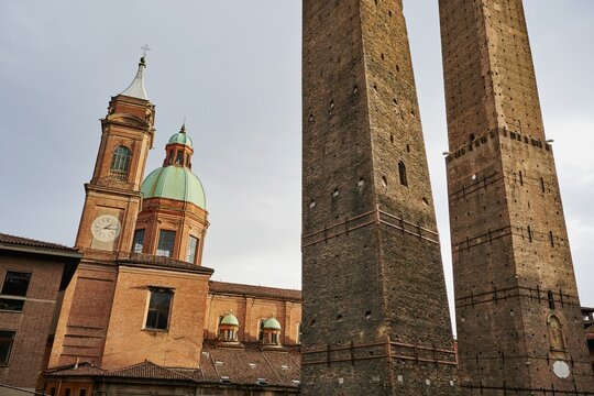 Garisenda and Asinelli towers, Santi Bartolomeo and Gaetano churches in the back, Bologna, Emilia-Romagna, Italy