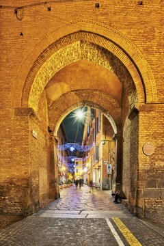 Old City Gate (Torresotto di Porta Nova), in the old town with Christmas lights, Bologna, Emilia-Romagna, Italy