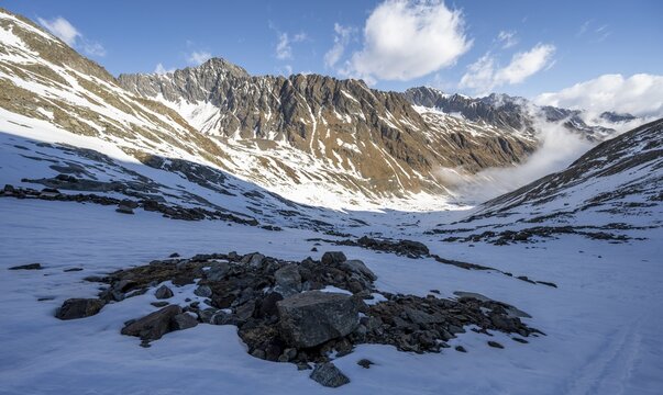 View of rocky mountain ridge into Oberbergtal, mountain landscape in winter, ascent to Alpeiner Ferner, Stubai Alps, Tyrol, Austria