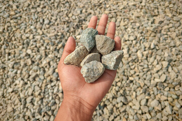 Crushed stone aggregate in hand commonly used in various landscaping and construction projects