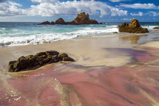 Pink Sand at Pfeiffer Beach in Big Sur, California with Coastal Rock Formations and Ocean Waves