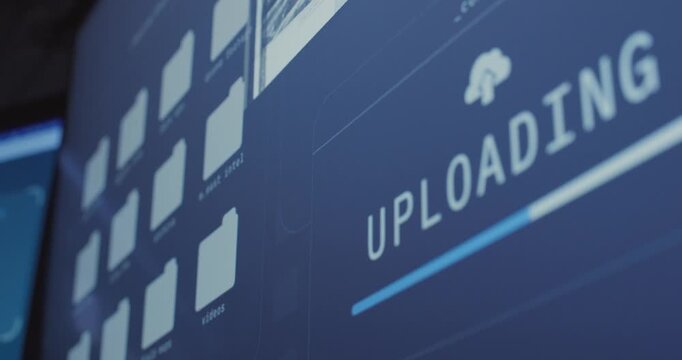 Close up on progress bar display on computer screen uploading secret files. Hacker or spy stealing documents and classified information data exposing and sending to server or remote network cloud
