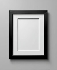Empty black picture frame with white mat on a gray wall, ready for art or a photo