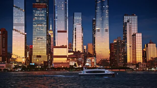 Bright soft light setting sun reflecting in the glass facades of New York skyscrapers. A modern boat moves along the waterfront with a Vessel Structure.
